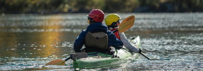 Travelers kayaking on crystal-clear waters
