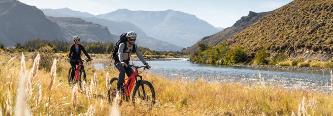 Two travelers riding a wide valley