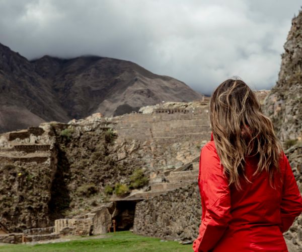 Women looking at archeological ruins in Ollantaytambo, Peru