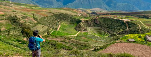 Person in the Maras archeological site in Peru.