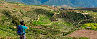 Person in the Maras archeological site in Peru.
