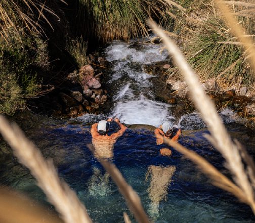 Couple enjoying puritama, Atacama.