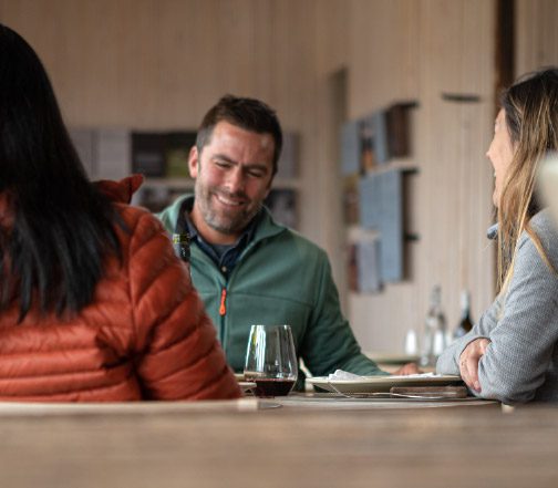 People having fun over a glass of wine at Torres del Paine Lodge