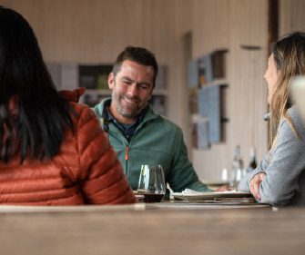 People having fun over a glass of wine at Torres del Paine Lodge